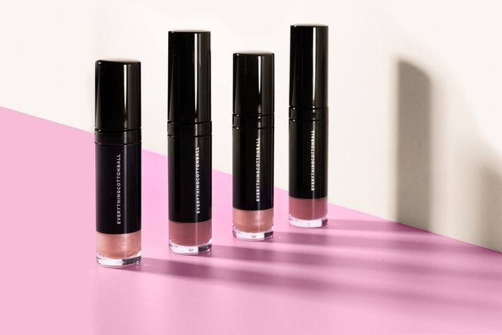 Nearly Naked and Peep Show lip glaze alternating in a styled product shot.